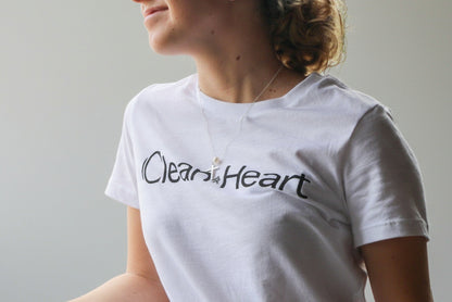 Person wearing a 'Clean Heart' t-shirt with palm trees in the background