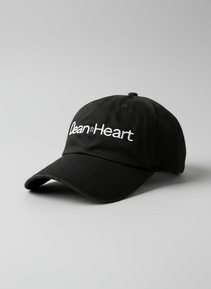 Black cap with 'Clean Heart' text on a textured surface