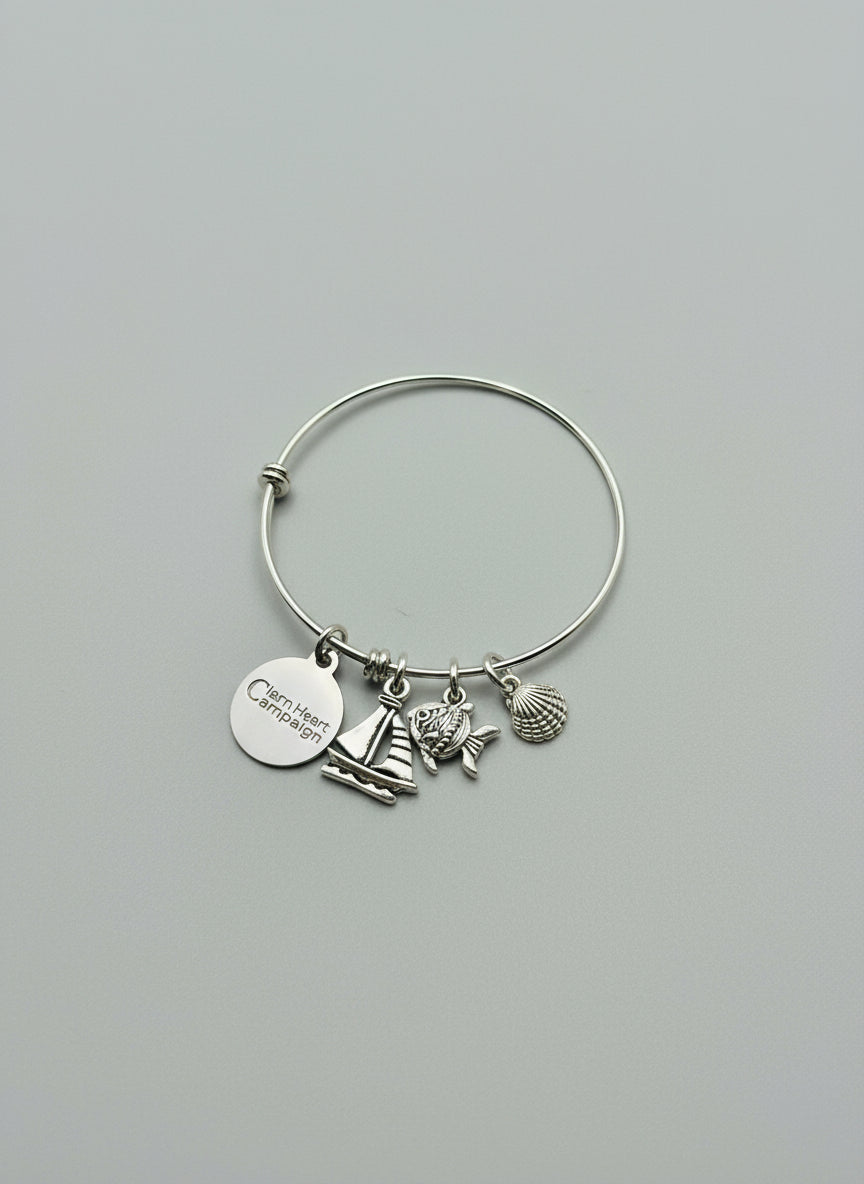 Silver bracelet with a "Clean Heart Campaign" tag and shell, fish and sailboat charms