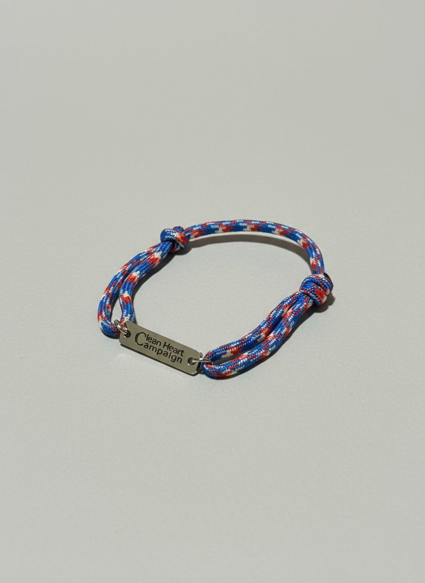 Multicolored braided bracelet with a silver tag