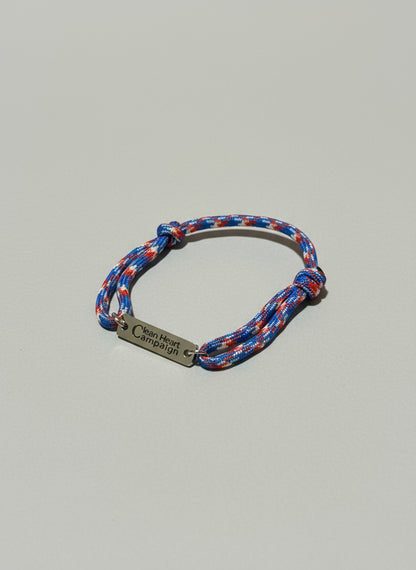Multicolored braided bracelet with a silver tag